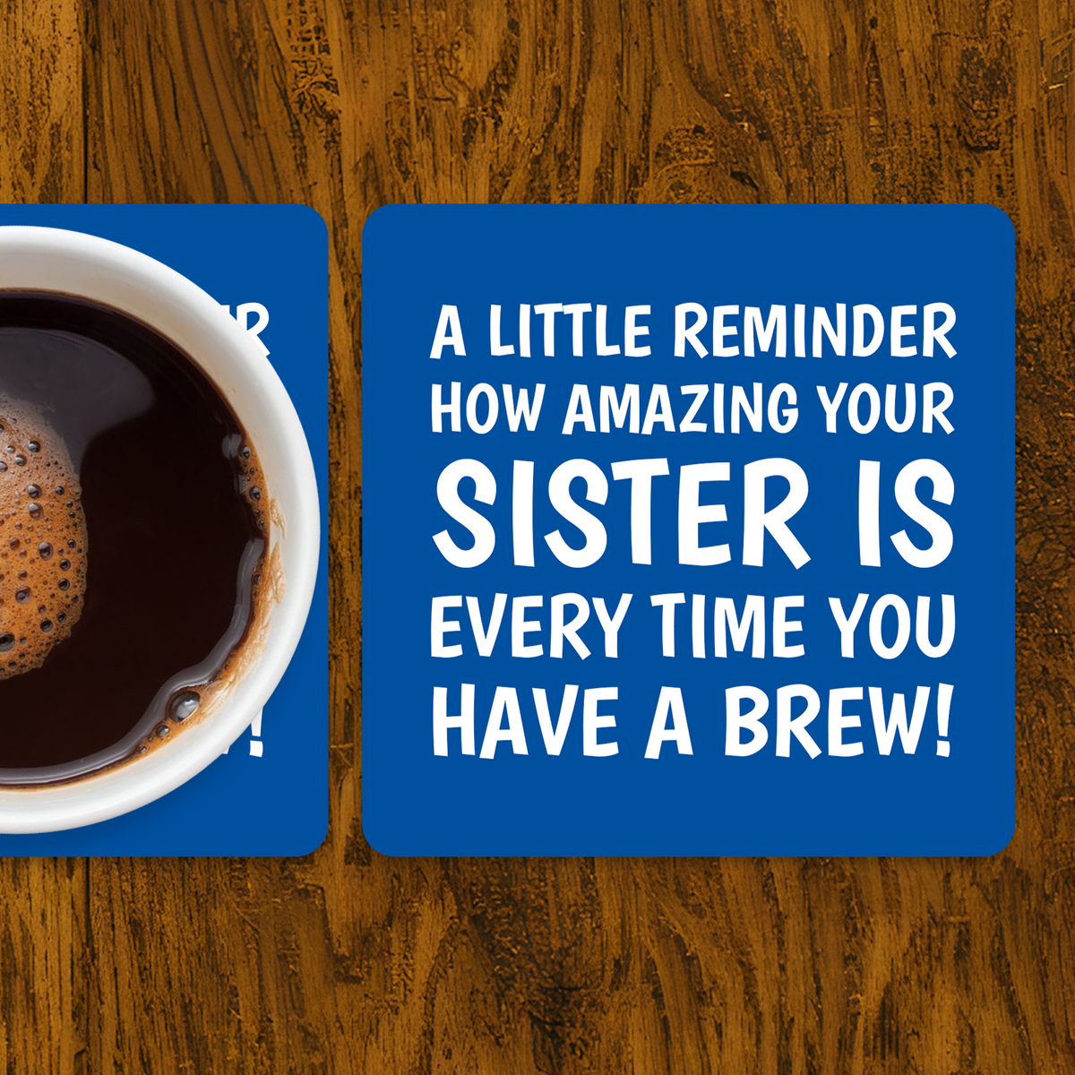 Coffee cup on a coaster with a humorous message about sisterhood on a wooden surface