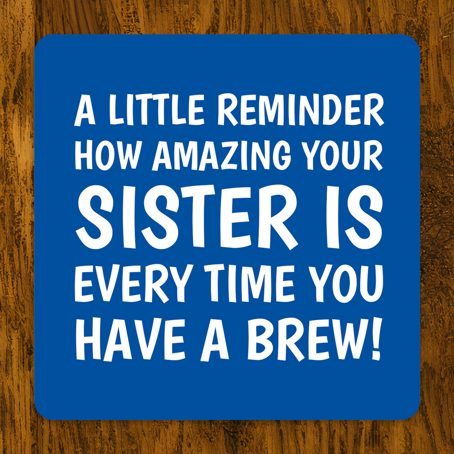 Blue coaster with white text on a wooden surface