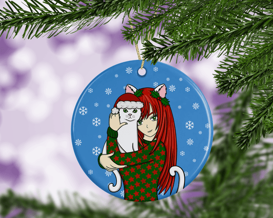 A round ceramic Christmas decoration to hang from a tree. Has a hand drawn illustration of an anime girl holding a white cat.