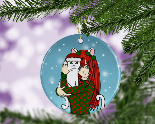 A round ceramic Christmas decoration to hang from a tree. Has a hand drawn illustration of a red haired anime girl and her white cat pet.