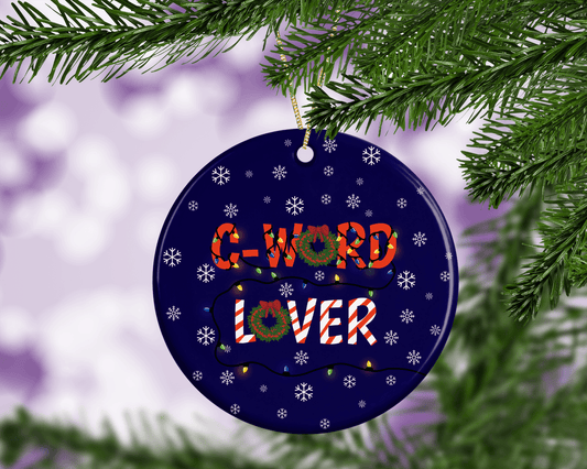 A ceramic Christmas tree decoration with the words C-word lover on it and a snowy blue background.