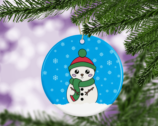 A round ceramic Christmas decoration to hang from a tree. Has a hand drawn illustration of a cute snowman with smiley face and with a blue snowy background.