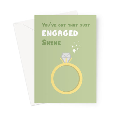 Just engaged greeting card with illustrated gold ring and sparkles on a sage green background