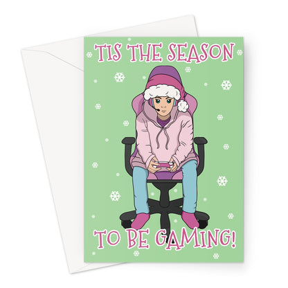 Funny gamer Christmas card featuring a person in a pink hoodie and Santa hat playing video games on a green background with snowflakes and the text “’Tis the Season to Be Gaming!”