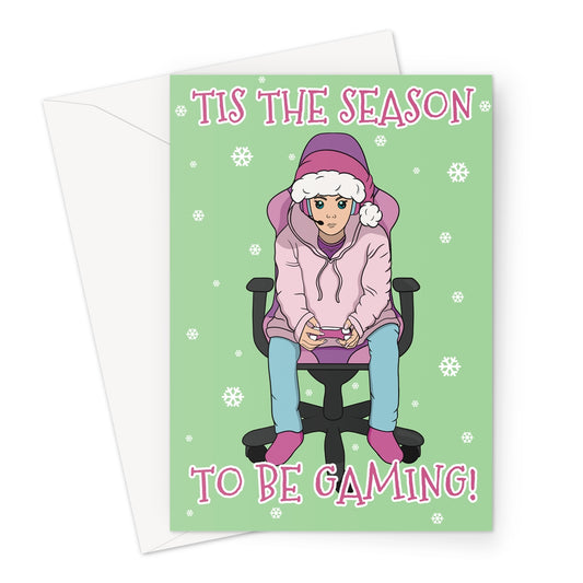 Funny gamer Christmas card featuring a person in a pink hoodie and Santa hat playing video games on a green background with snowflakes and the text “’Tis the Season to Be Gaming!”