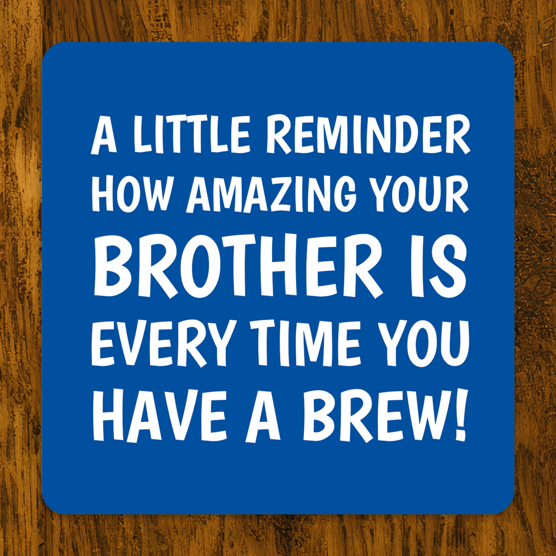 Blue coaster with white text on a wooden surface