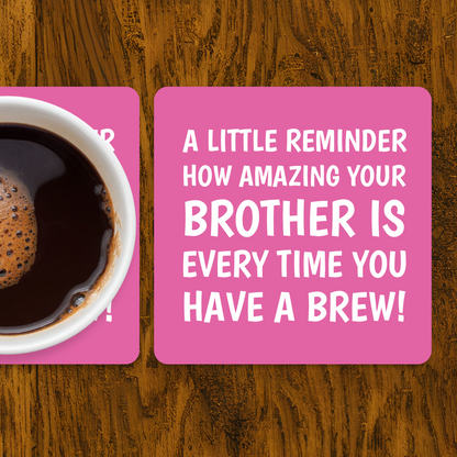 Coffee cup on a pink coaster with a humorous message on a wooden surface
