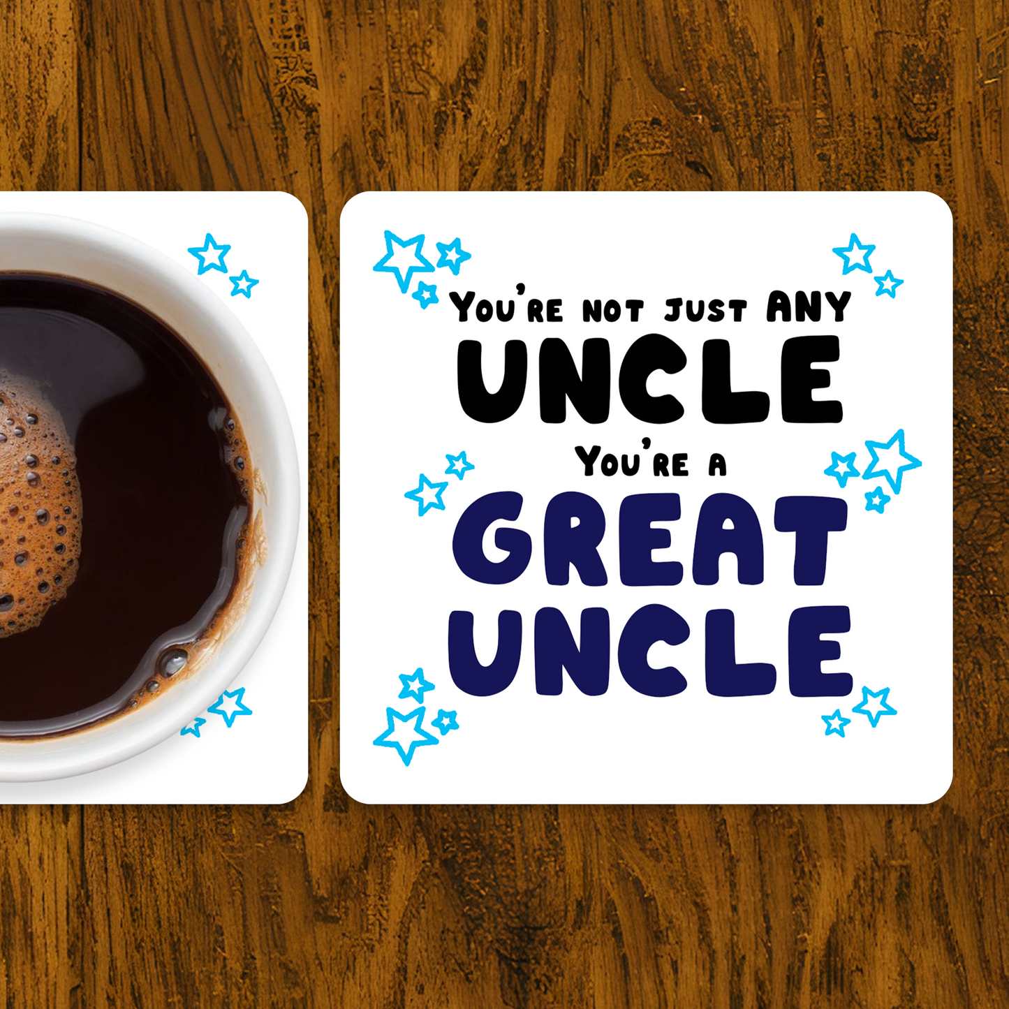 Coaster with 'You're not just any uncle, you're a great uncle' text next to a cup of coffee on a wooden surface