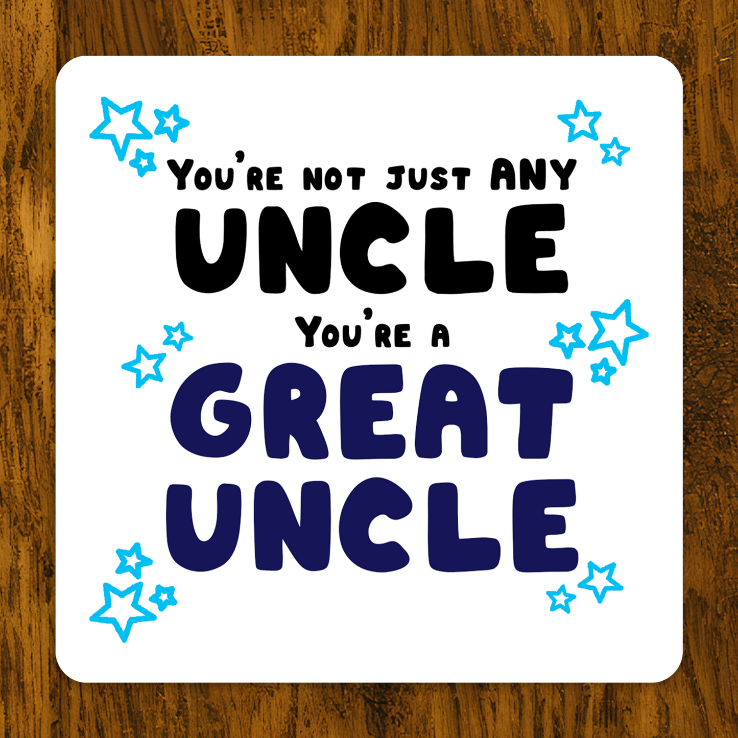 Card with text 'You're not just any uncle, you're a great uncle' on a wooden surface