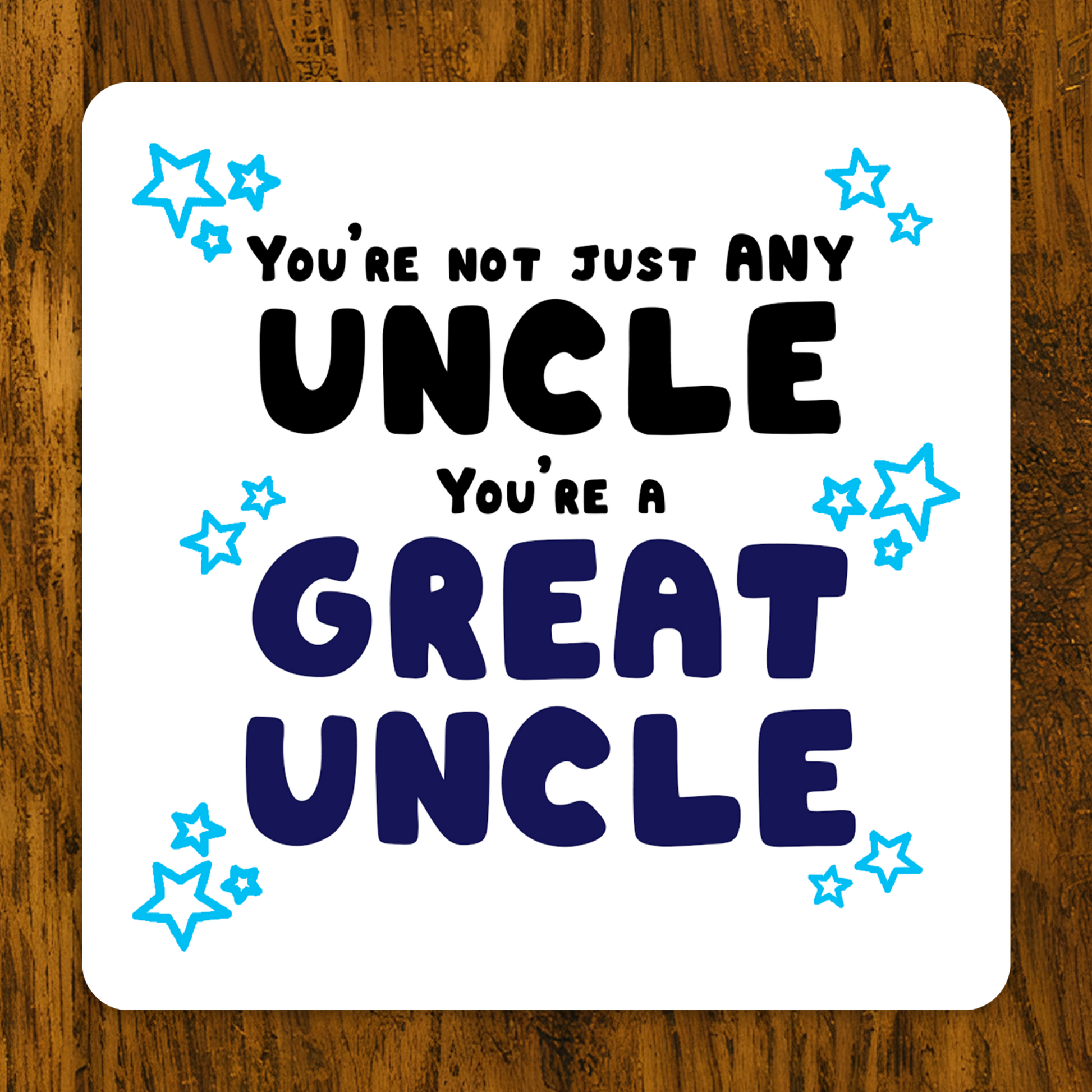 Card with text 'You're not just any uncle, you're a great uncle' on a wooden surface