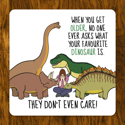 Cartoon illustration of a person surrounded by dinosaurs with humorous text on a wooden background