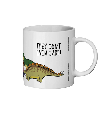 White mug with a dinosaur graphic and text 'THEY DON'T EVEN CARE!' on a white background