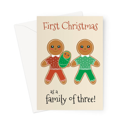LGBTQ+ Christmas card with two gingerbread parents and a gingerbread baby, text reads “First Christmas as a family of three.” Inclusive festive card for same sex families.