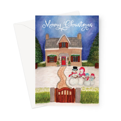 Illustrated Christmas card with a snow-covered cottage, red door, and smiling snowman family in the garden.
