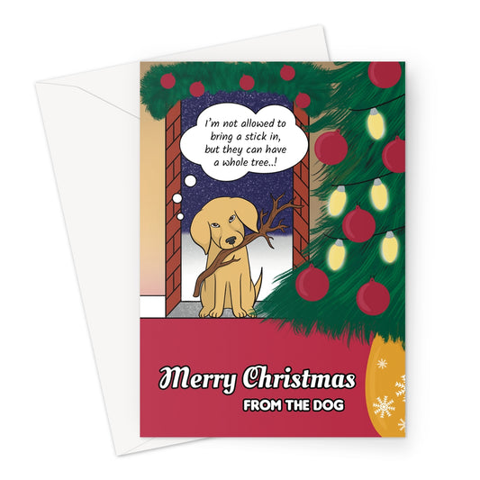 Funny Christmas card from the dog featuring a cute Labrador holding a stick and saying “I’m not allowed to bring a stick in, but they can have a whole tree..!” with a decorated Christmas tree beside him.