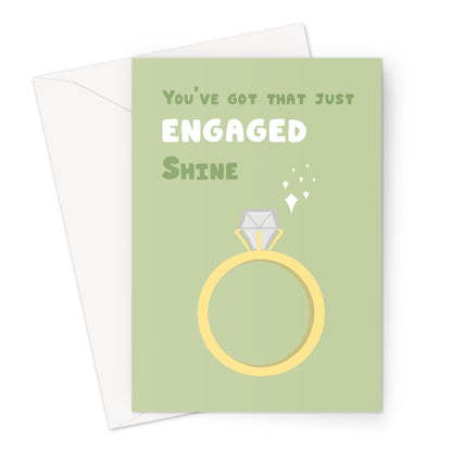 Just engaged greeting card with illustrated gold ring and sparkles on a sage green background