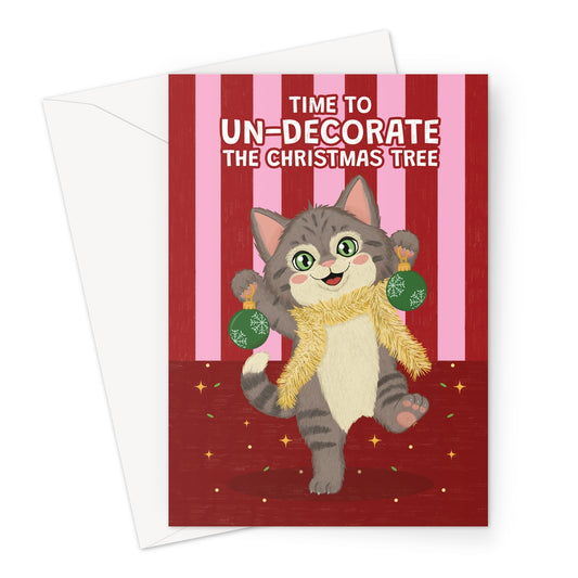 funny cat Christmas card with cat wearing tinsel holding baubles and un-decorate the Christmas tree message