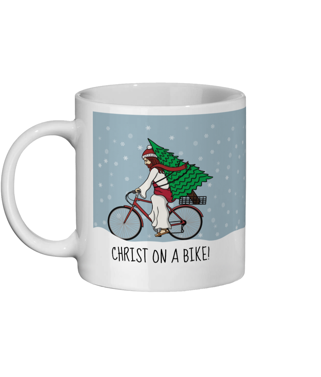 Funny Christmas ceramic mug with illustration of Christ riding a bike carrying a Christmas tree and text “Christ on a Bike” - Left Side