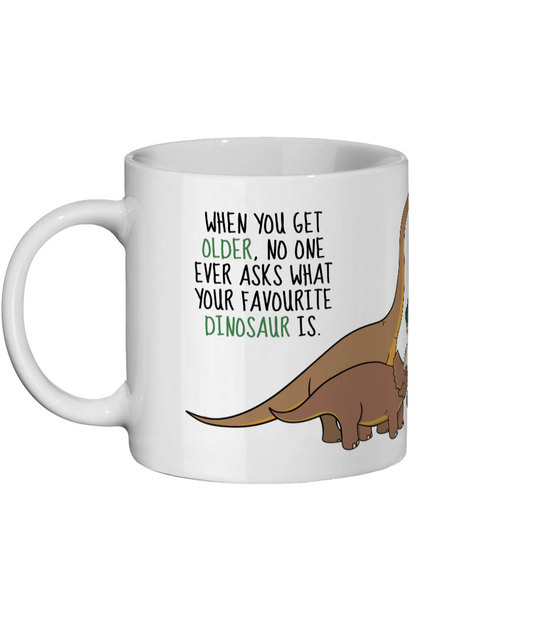 Funny dinosaur meme mug featuring the quote nobody asks what your favourite dinosaur is anymore with cartoon dinosaurs - Left Side